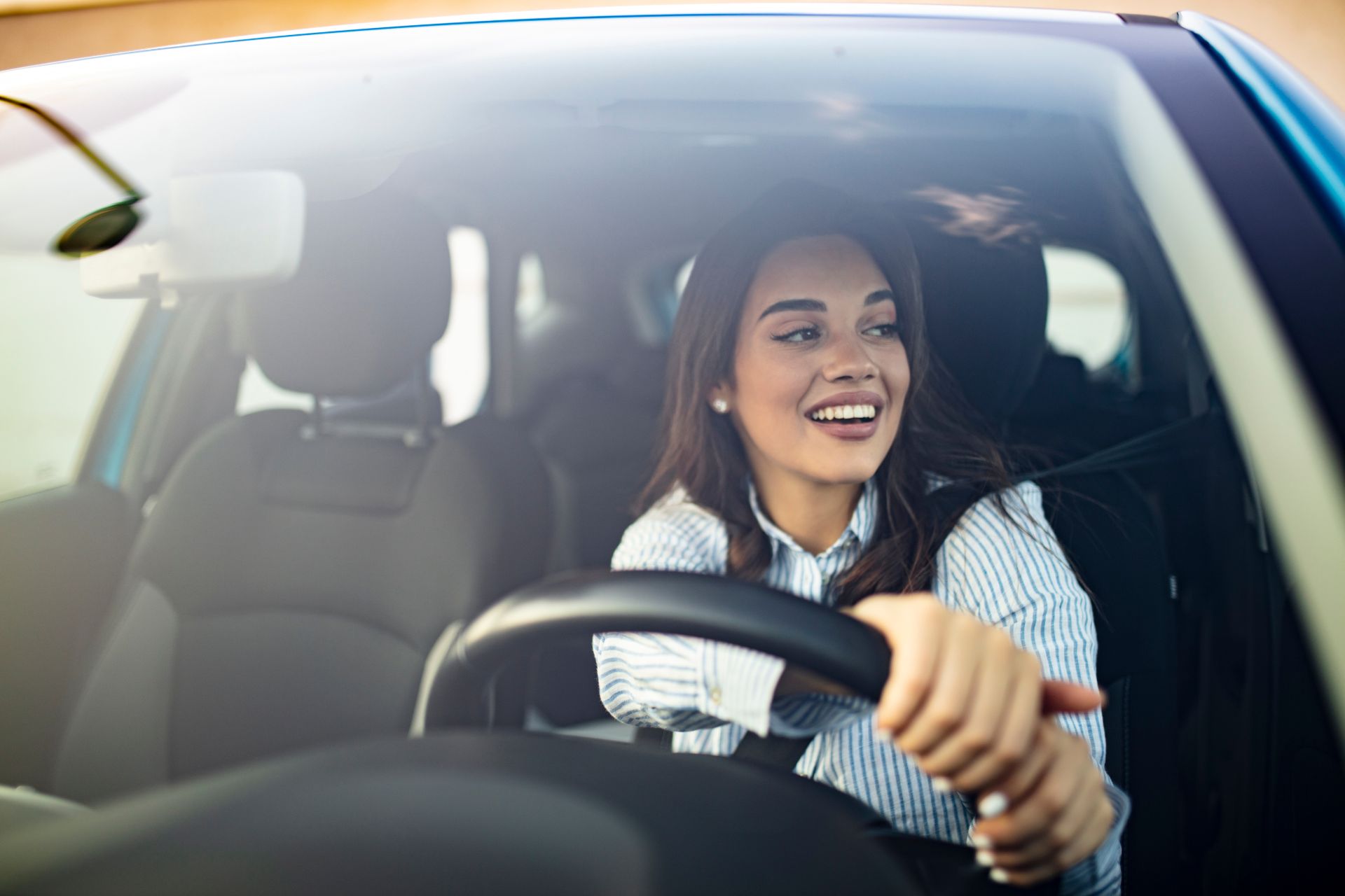 Woman driving car house
