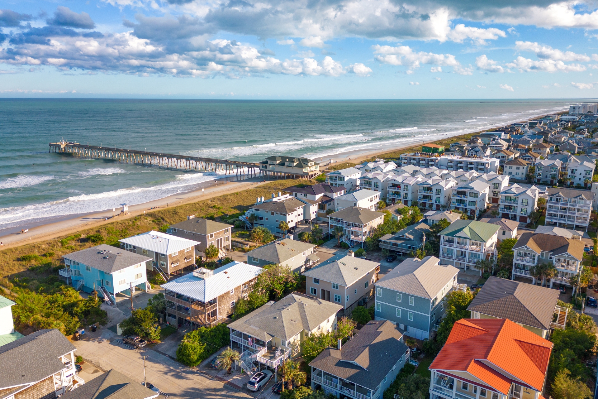 Home and coastal property insurance | FinPoint Insurance Group Aerial view of beachfront homes and a pier along the Carolina coast, representing FinPoint’s home and coastal property insurance coverage for homeowners
