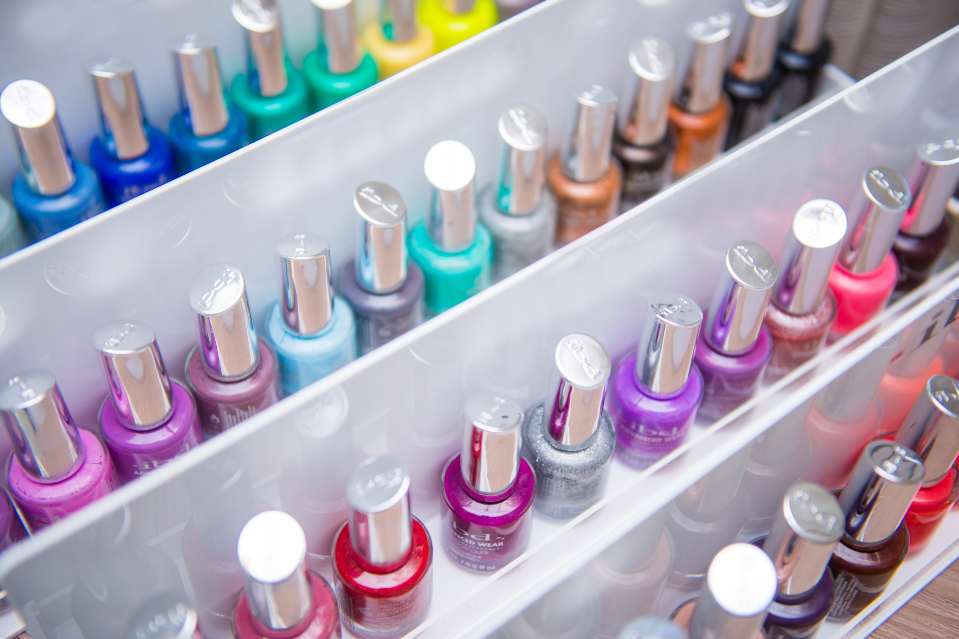 Nail polish colors organized in salon display rack