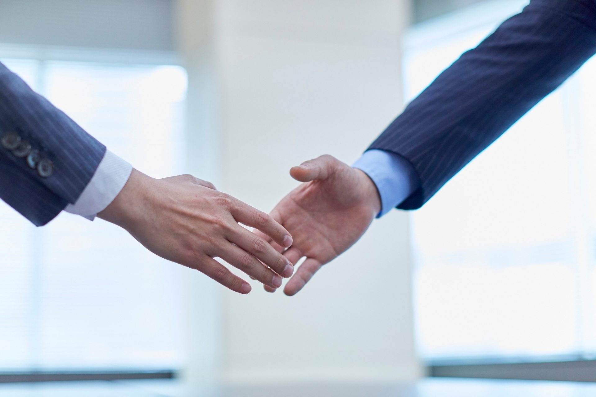 business handshake between professionals representing client relationship and financial services agreement